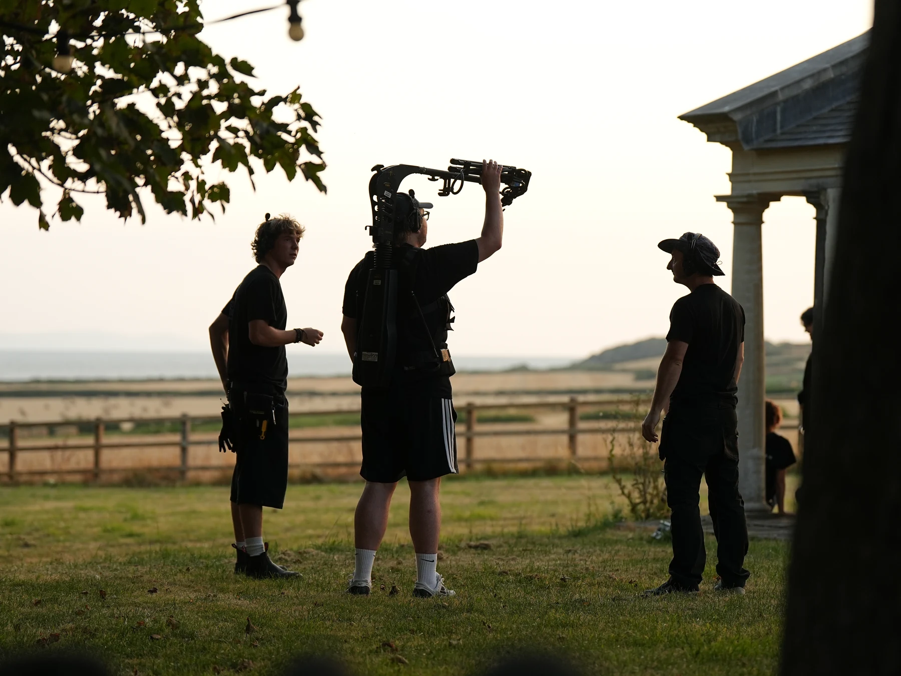 Crew positioning an overhead light beside the coast