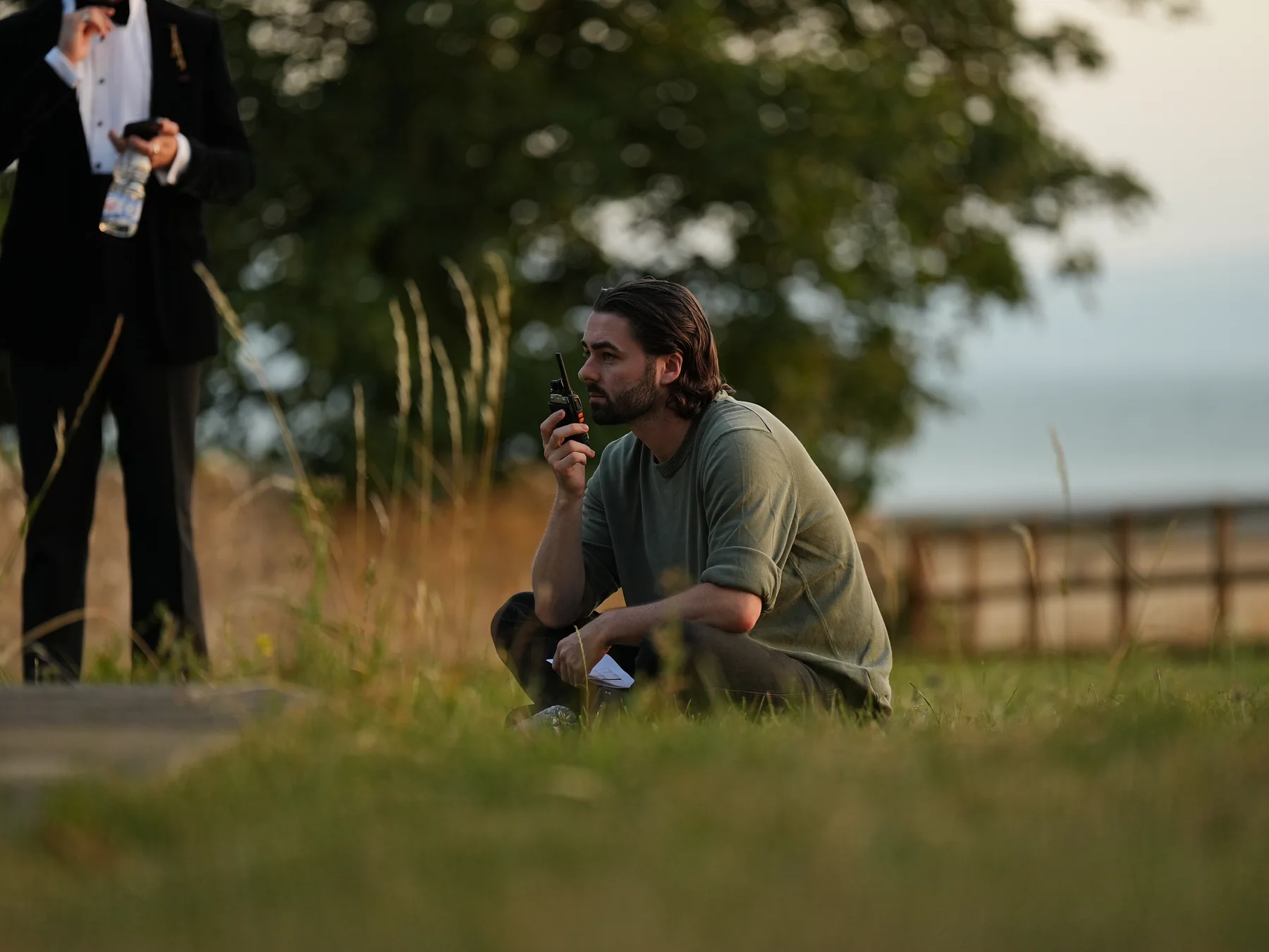 Crew member working beside an outdoor filming location