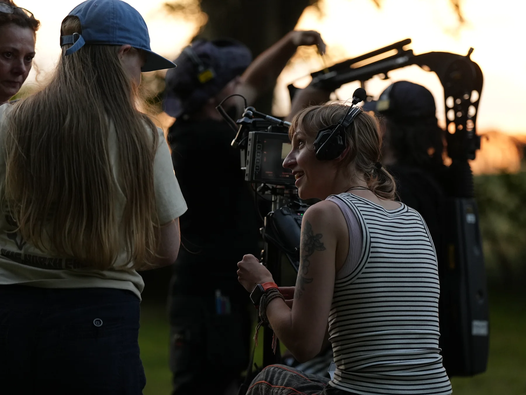 Production crew gathered around a camera rig outdoors