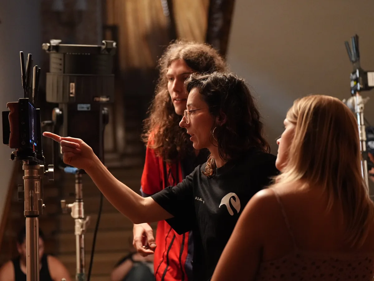 Crew preparing a lighting setup indoors