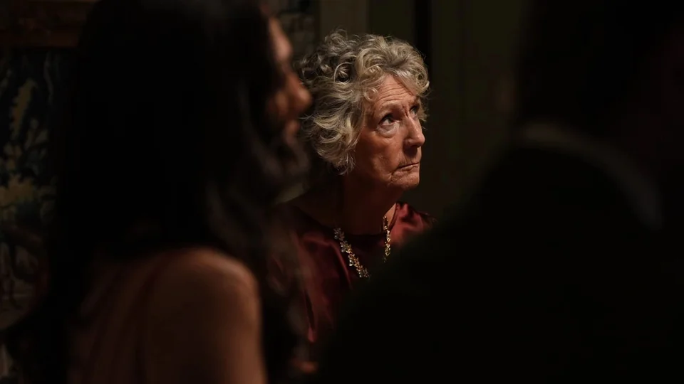 Eliza Macintosh at a dinner scene in Murder at Macintosh Manor
