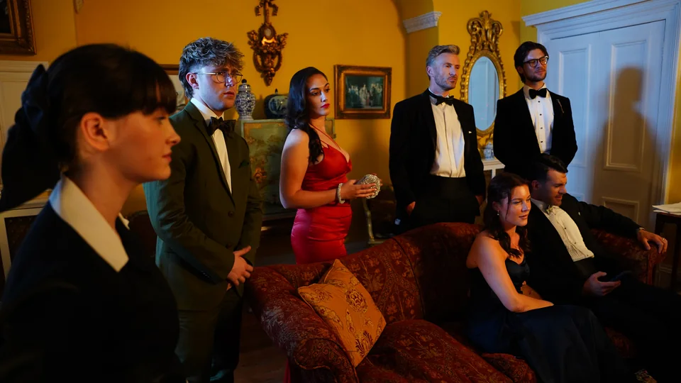 The family gathered in the drawing room in Murder at Macintosh Manor